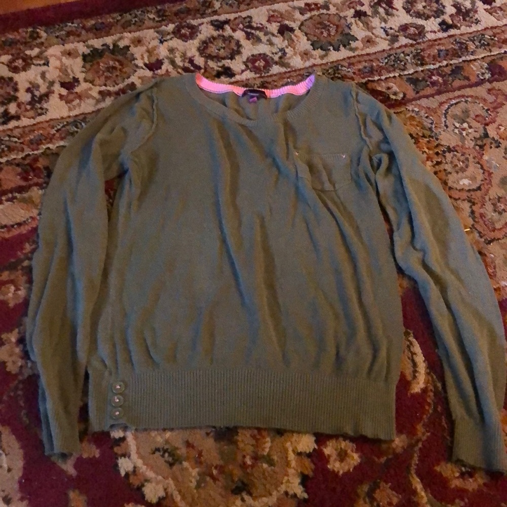 Green sweater with pink stitching